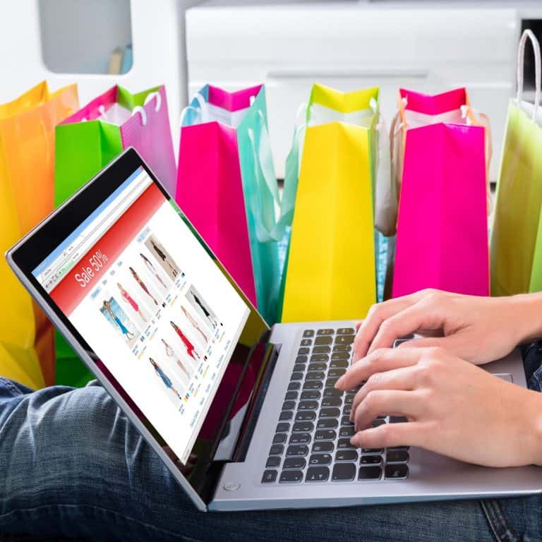 shopping online computer with bags in background