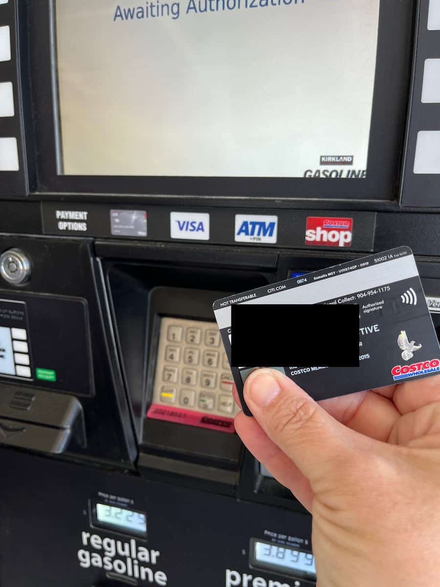holding costco credit card at gas pump