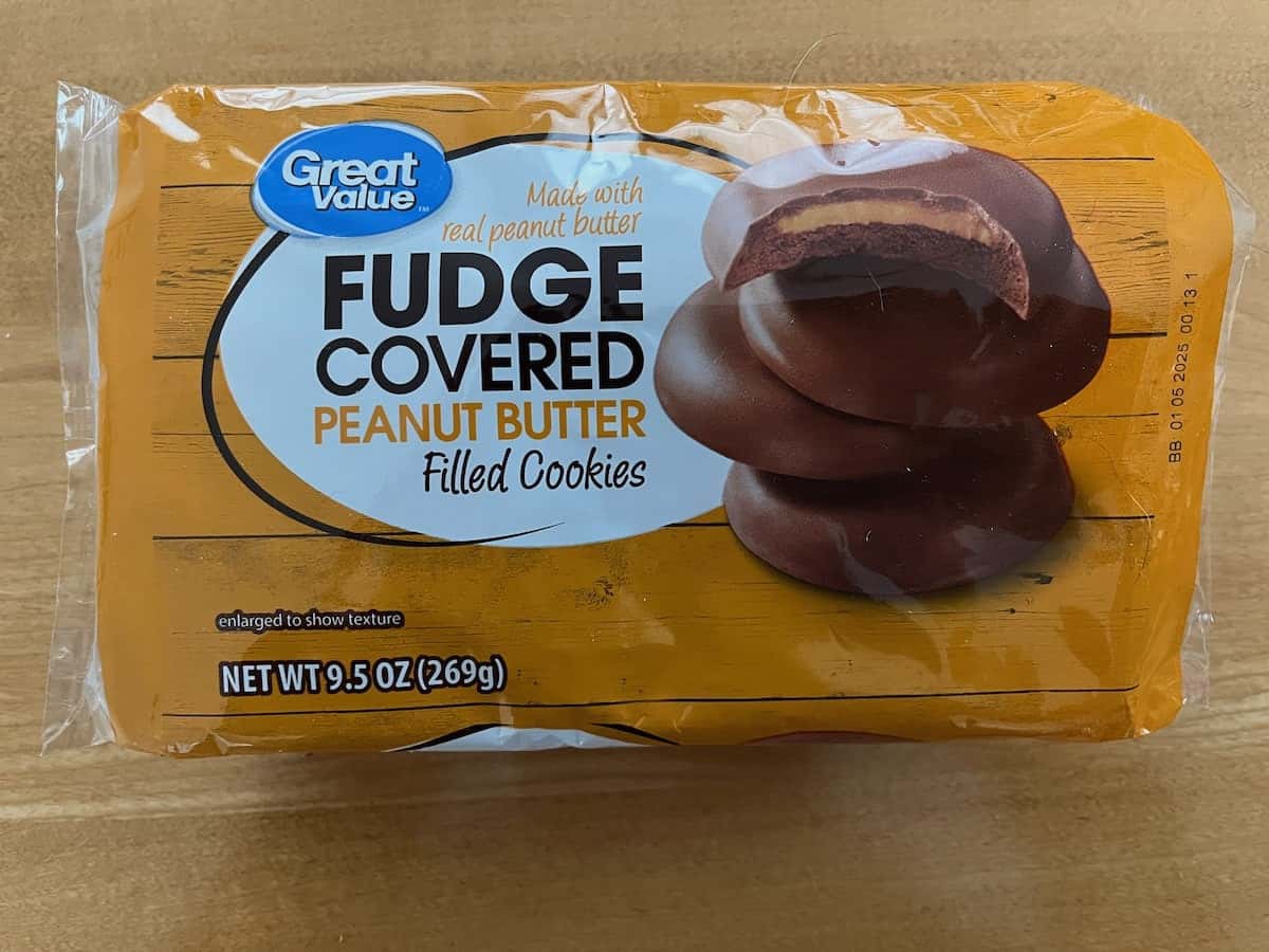 A package of great value generic girl scout cookies, fudge covered peanut butter filled, on a wooden surface.