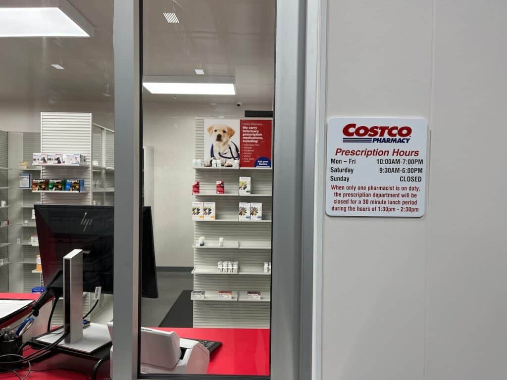 Sign about pet prescriptions at Costco pharmacy window.