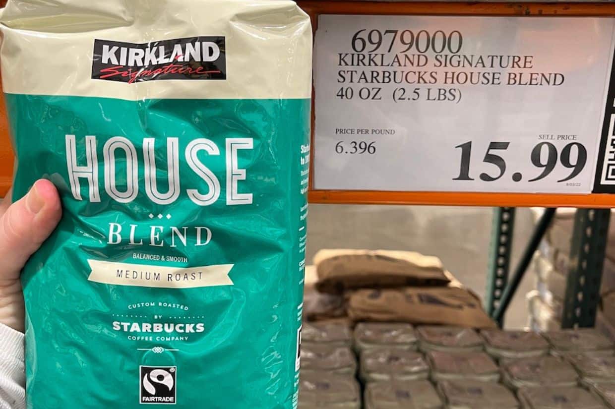 Holding up a bag of Starbucks coffee.