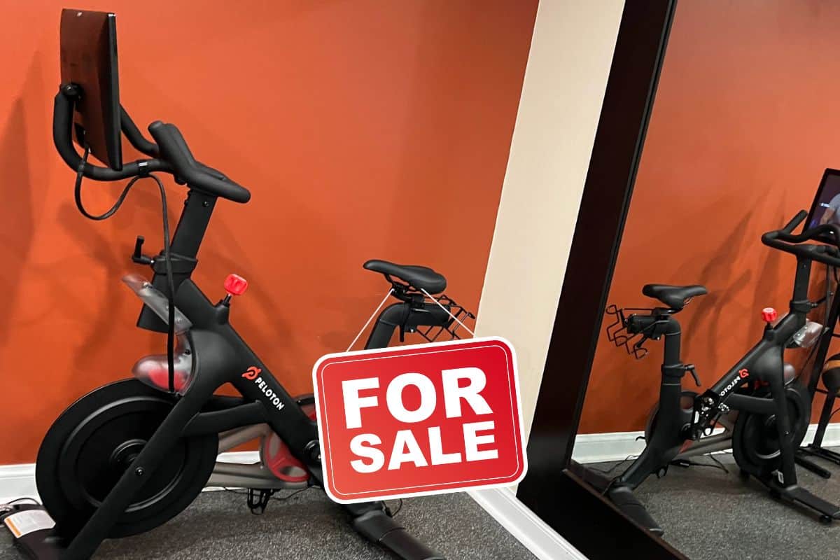 A Peloton bike with a for sale sign on it.