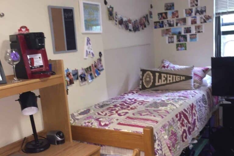 College dorm room with made bed with Lehigh pillow on it.